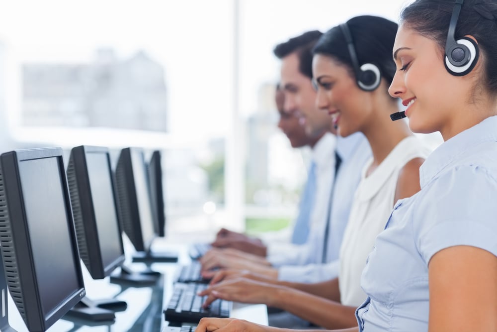 Call centre workers working in line with their headsets